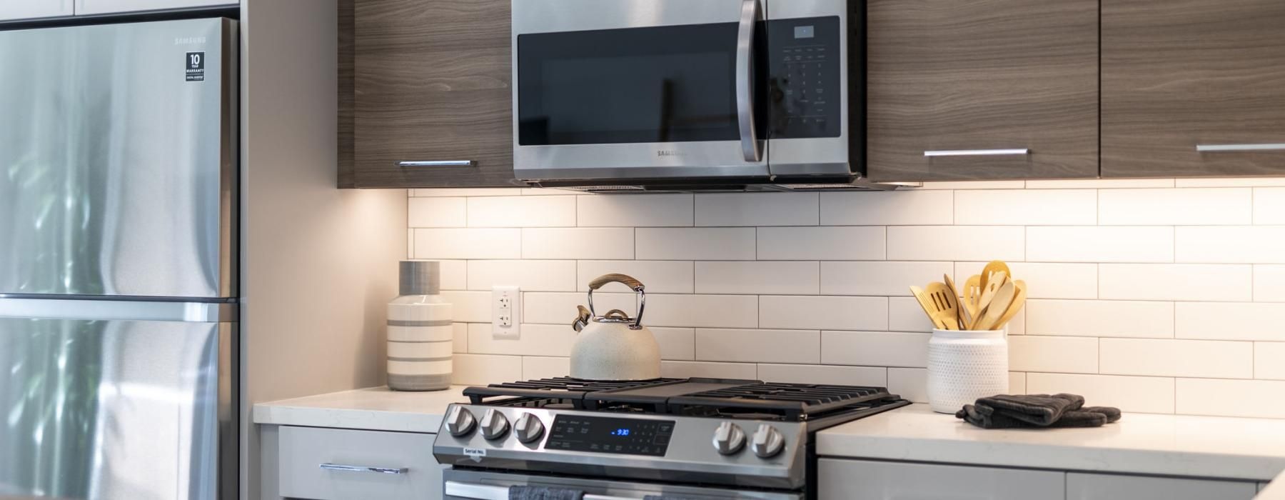 a kitchen with a stove and microwave