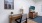 desk with chair , lamp, and a plant along wall in a livingroom
