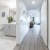 a white bathroom with a wood floor